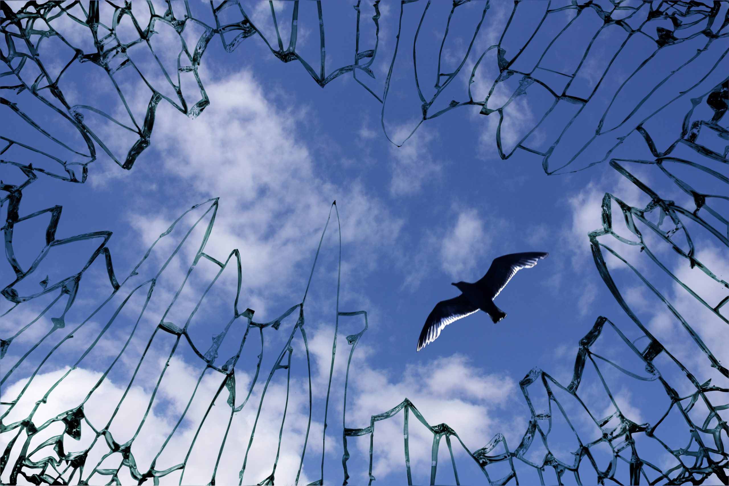 Broken,Window,Glass,With,View,To,Blue,Sky,-,Symbol