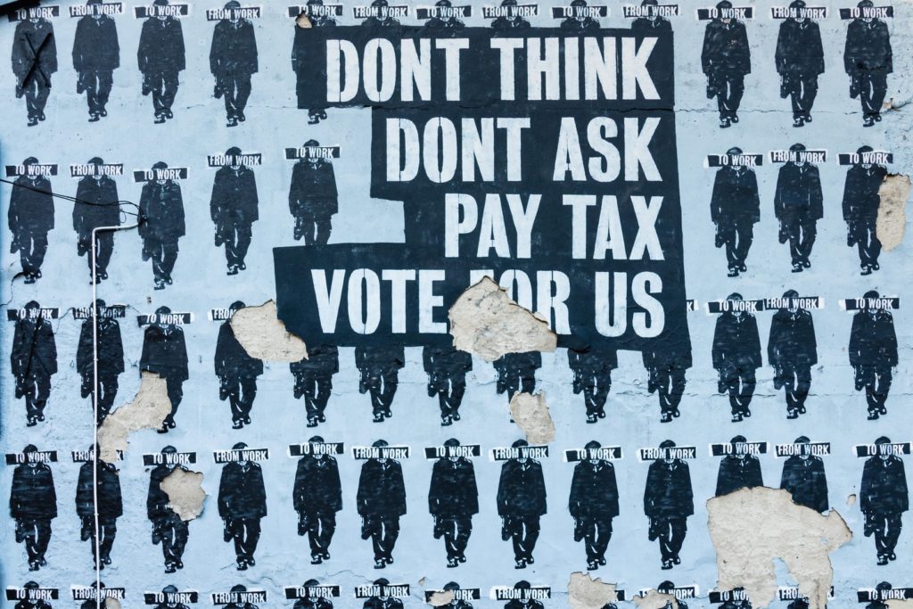 Political street art Don't think, don't ask, pay tax, vote for us