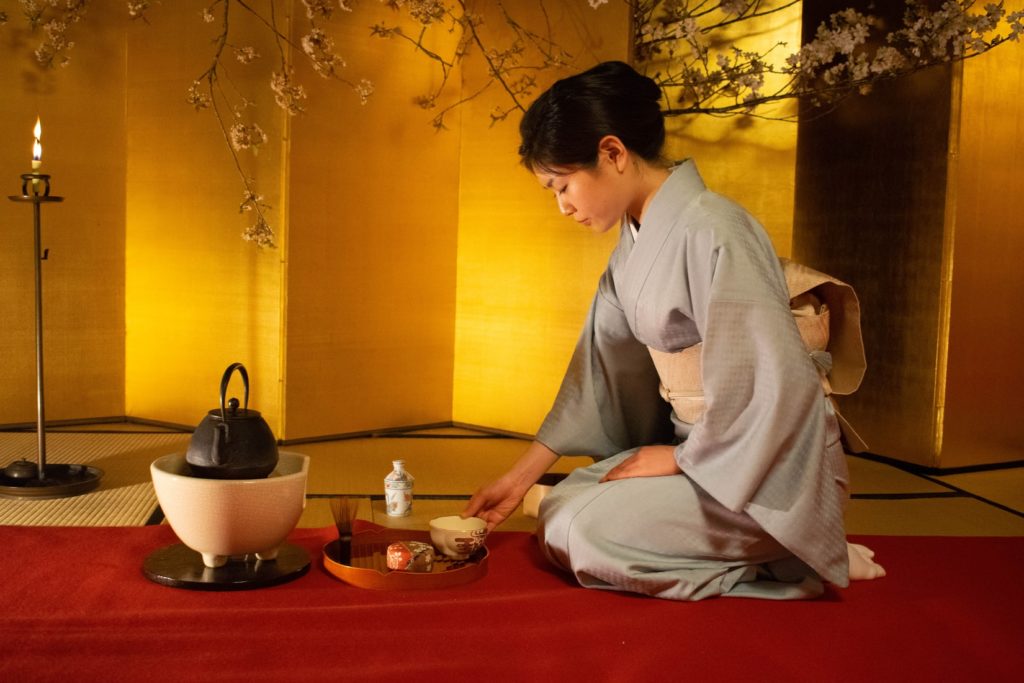 A Japanese woman serving tea