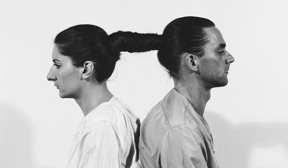 Black and white photo of a man and a woman connected with their hair - performance art by Marina Abramovic